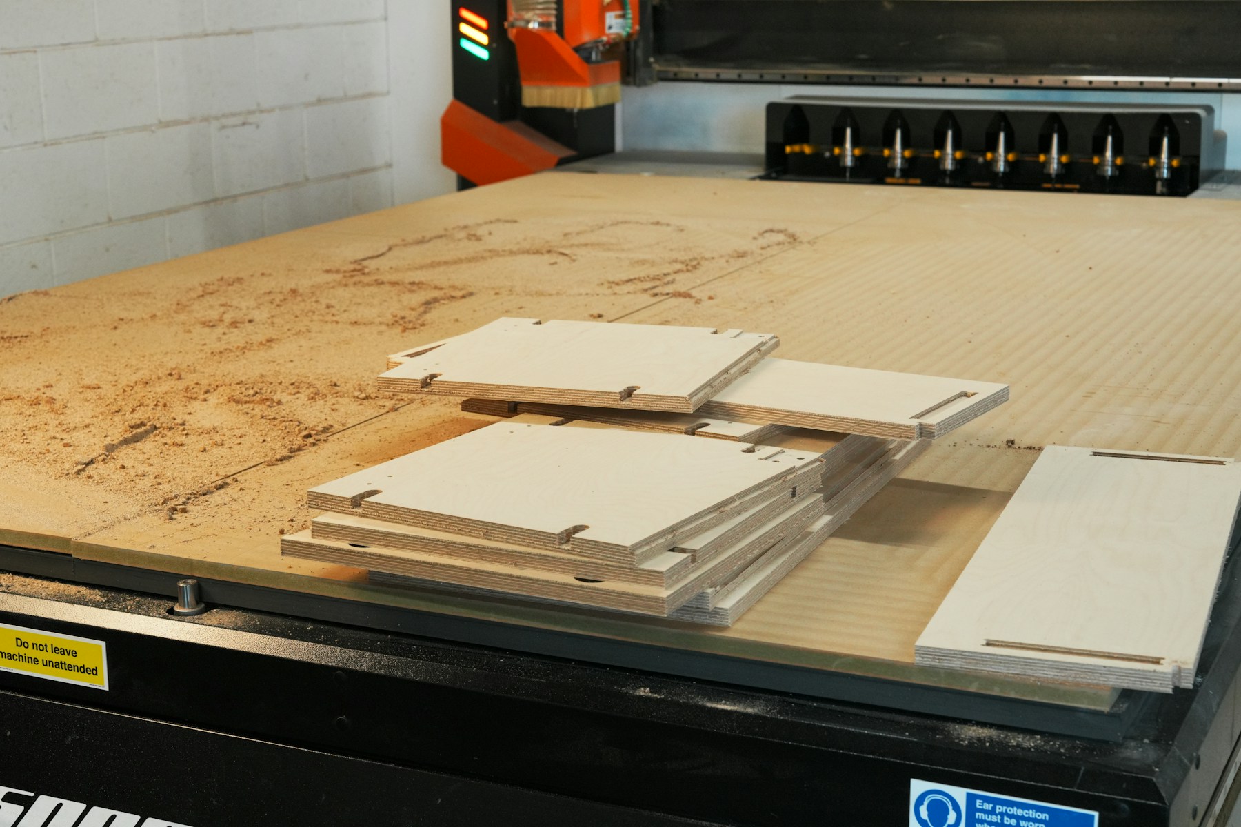 CNC machine bed with stacked wooden pieces
